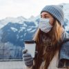 Coronavirus girl in mask drinking coffee
